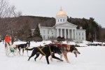 Jim Blair, owner and head musher at Eden Dogsledding, runs his team around the Statehouse lawn on Thursday. Photo by Josh Larkin.