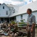 George Schenk, owner of American Flatbread and the Inn at Lareau Farm in Waitsfield, looks over a pile of flood ravaged goods removed from the inn and restaurant. VTD/Josh Larkin