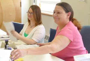 Workers at the Eligibility Benefits Center in Waterbury sort through applications.