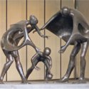 Three-piece sculpture of mother, father, and child by sculptor Joseph J. O'Connor at the entrance to the American Dental Association building on Chicago Avenue east of Michigan Avenue in Chicago, Illinois. Photo by Terence Faircloth.