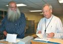 State archivist Gregory Sanford chats with historian and author Michel Sherman in the state archives headquarters in Middlesex Wednesday.  Photo by Andrew Nemethy