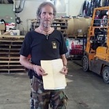 Jeremy Dodge of East Montpelier holds the folder on which Gov. Peter Shumlin sketched out the details on the sale of Dodge's property. Photo by Andrew Stein/VTDigger