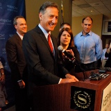 Gov. Peter Shumlin signing a patent abuse protections bill into law today at the Vermont Chamber Business and Industry EXPO in South Burlington. Peter Kunin, intellectual property lawyer at Downs Rachlin Martin, PLLC, to his right, Betsy Bishop, president of the Vermont Chamber of Commerce, to his near left, and Jerry Tarrant, chief financial officer at MyWebGrocer, to his far left. Photo by Johnny Herrick/VTDigger