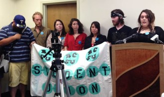 Marcia White reads a statement from Burlington College's student union. Photo by Laura Krantz/VTDigger 