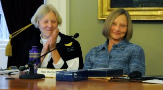 Rep. Martha Heath, D-Westford, chair of the House Appropriations Committee (right) reacts as state Building and Grounds Commissioner Mike Obuchowski congratulates her on her years of service Wednesday at a meeting of the Legislature's Joint Fiscal Committee. Heath did not seek re-election this year. Photo by Hilary Niles/VTDigger