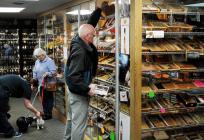 Bob Kruse of Bradford selects cigars from the humidor at UnDun in West Lebanon, N.H. Photo by James M. Patterson/Valley News