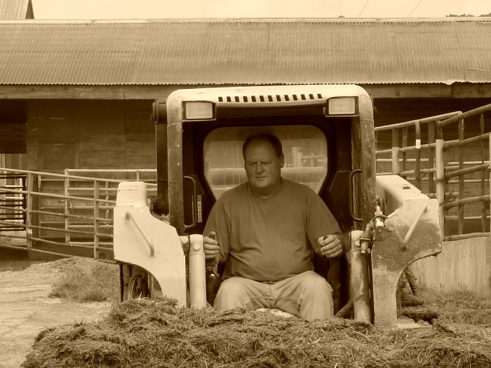 Eric Clifford runs a skidsteer on his farm in Starksboro.