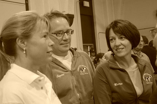 Marie Audet, right, talks with her husband Eugene and Margaret Laggis at a hearing in St. Albans recently. Audet is one of the founders of Dairy Farmers Working Together, a grassroots group that is pushing a growth management program for the dairy industry. Photo by Terry J. Allen.