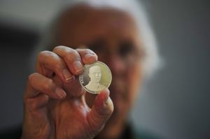 Thomas Naylor holds a Second Vermont Republic silver coin, photo by Peter Miller