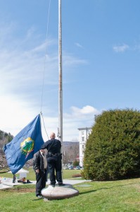 Vermont Capitol police officers taking down the Vermont flag in front of the Statehouse. VTD/Josh Larkin.