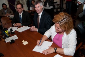 Mark Larson, Michael Fisher, Full Rep. Sarah Copeland-Hanza, D-Bradford, signing H.202 out of conference committee earlier this week Also pictured are Rep. Mike Fisher, D-Lincoln, left, and Rep. Mark Larson, D-Burlington. VTD/Josh Larkin