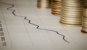 Stock chart and coins. Photo by Ken Teegardin, www.seniorliving.org.