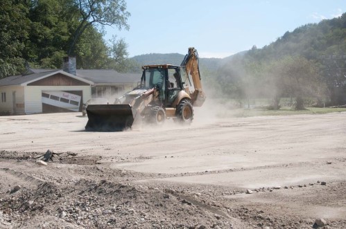 A bucket loader clears silt away from roadways near the CVPS substation in Rochester. VTD/Josh Larkin