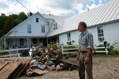 George Schenk, owner of American Flatbread and the Inn at Lareau Farm in Waitsfield, looks over a pile of flood ravaged goods removed from the inn and restaurant. VTD/Josh Larkin