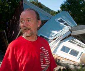 Jon Graham stands in front of what's left of his house after Tropical Storm Irene tore through Rochester. VTD/Josh Larkin