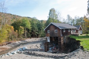 A house on Quarry Hill Road in Rochester is braced from below with railroad ties. VTD/Josh Larkin