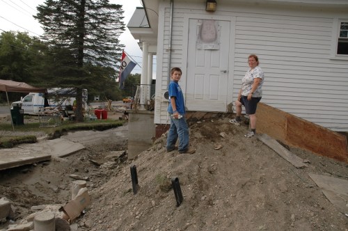 Christy Hazen, presdent of The Friends of West Hartford Library, stands with her son at what used to be the handicapped accessible ramp into the building. Rebuilt after the 1927 flood, the flood of 2011 ruined many of the books and left the building damaged. VTD/Andrew Nemethy