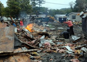 20111024_thersaHaskinsSueLevine Theresa Haskins and Sue Levine pitch lumber from their home into the bonfire in Patterson Park. Photo by Gordon Miller.