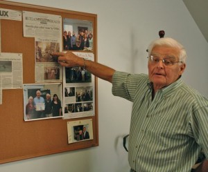 Weekly Standard publisher Phil Camp points to an article in the Rutland Herald about his staff's determination to go on publishing after floodwaters destroyed the offices of the newspaper. Photo by Andrew Nemethy