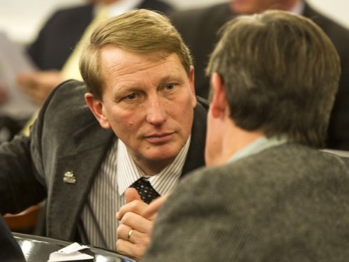 Rep. Mark Higley, R-Lowell, talks with Rep. Chip Conquest, D-Groton, at a hearing on gas prices t the Statehouse Tuesday afternoon. Photo by Roger Crowley