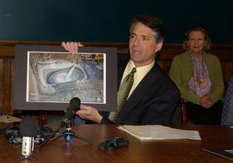 Paul Burns, executive director of VPIRG, holds up a photo of a fracking operation. VTDigger staff photo.