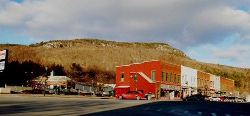 Hogback Mountain crests like a wave beyond Bristol Village. Red pine stands, along with white pines, are visible along the rocky ledges near the top of the mountain. Photo by Audrey Clark