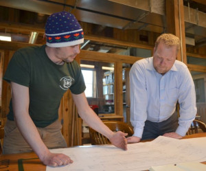 Will Wiquist, executive director of the Green Mountain Club, right, and Matt Wels backcountry builder for the club, look over plans for the new Winooski River bridge. Photo courtesy of GMC