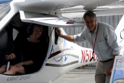 Alexandra MacLean of Jay Peak gets a tour of the CTLS cockpit from the plane’s owner, Gary Forrester, of Newport, N.H. Photo by Hilary Niles/VTDigger 