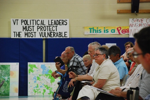 South Burlington residents voiced their positions on the F-35 basing project at Monday night’s city council meeting at the Chamberlin School in South Burlington. In the center is Carmine Sargent, a 41-year resident of Elizabeth Street in South Burlington, who opposes the basing project. Photo by John Herrick/VTDigger