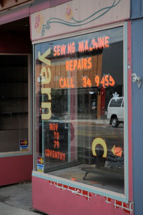 A sewing and yarn shop on Newport's Main Street directs customers to its new location. The block is being cleared of tenants in preparation for demolition, to make way for a new mixed-use block that's part of a larger development on Lake Memphremagag. Photo by Hilary Niles/VTDigger