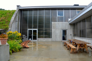 Seven concrete cheese ripening "caves," temperature and humidity controlled, stretch underground like spokes from a hub behind this entry way to the offices at Jasper Hill Farm. Some 330,000 cubic yards of concrete went into their construction. Photo by Andrew Nemethy