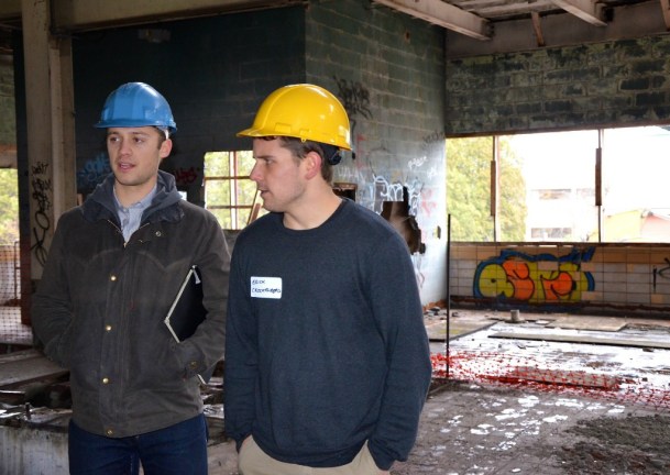 Tad Cooke, left, and Erick Crockenberg, standing on the upper level of the derelict Moran power plant on Burlington's waterfront, talk about their innovative renovation proposal for the iconic building. The plan by the two University of Vermont seniors has won highest marks in a competition to enhance the city's downtown. Photo by Andrew Nemethy