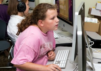 Fifth-grade students Destiney and Brook (in the background) in Windy Kelley's classroom at Union Elementary School in Montpelier edit an online book report blog. Photo by Roger Crowley/for VTDigger