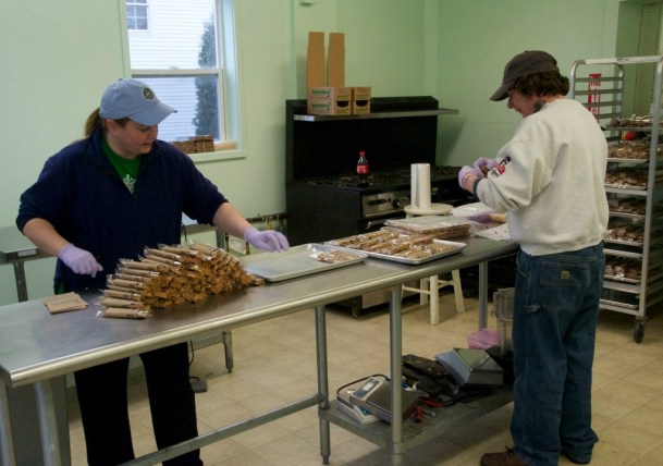 Randi Kay and an employee pack Mike Rosenberg’s Garuka Bars at her commercial kitchen, New World Enterprises, in Winooski. Some 4,000 to 6,000 are produced each month. Photo by Dirk Van Susteren 