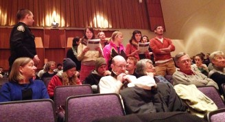 Protesters interrupt the Canadian Ambassador to the U.S., Gary Doer, at St. Michael's College in Colchester on Feb. 10, 2014. Photo by Hilary Niles/VTDigger 