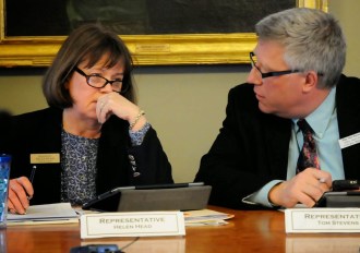 Reps. Helen Head, D-South Burlington, and Tom Stevens, D-Waterbury, chat after voting to raise Vermont's minimum wage. Photo by Hilary Niles/VTDigger