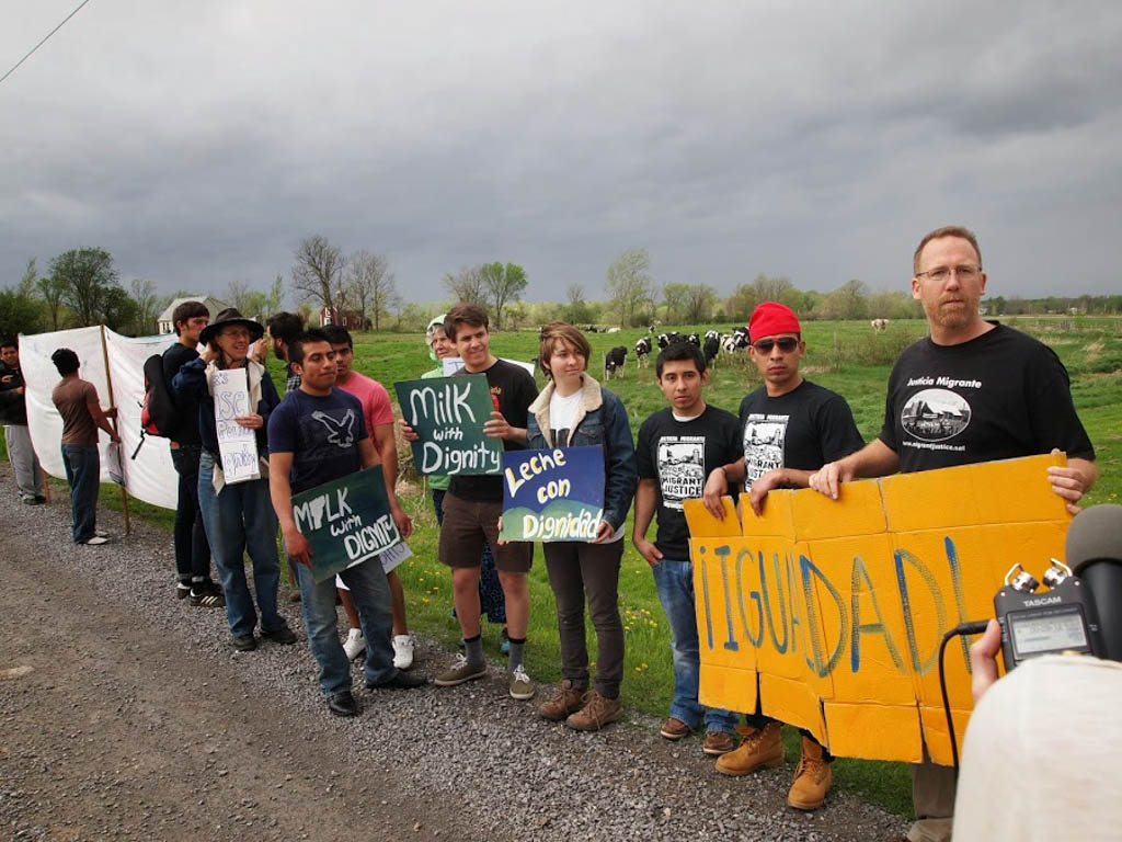 Demonstrators line the road near a Ferrisburgh farm. Migrant Justice photo