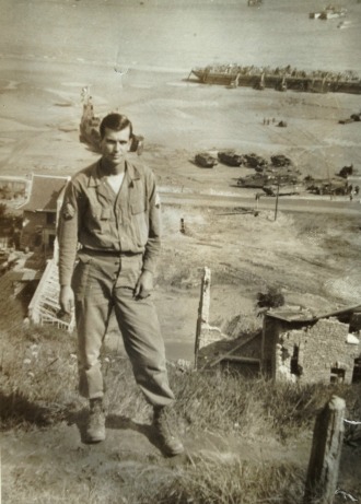 Leonard Pilus of Essex Junction on the bluffs above Omaha Beach several weeks after the Normandy invasion. He recalled his arrival on the beach under German fire: "You crawled like a crab. You had to get off the beach because down there you were an open target."
