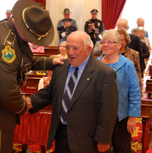 Rolland Lafayette, 85, is congratulated by Col. Thomas L'Esperance for his help in the 1944 rescue of survivors of a B-24 plane crash on Camels Hump. Photo by Laura Krantz/VTDigger