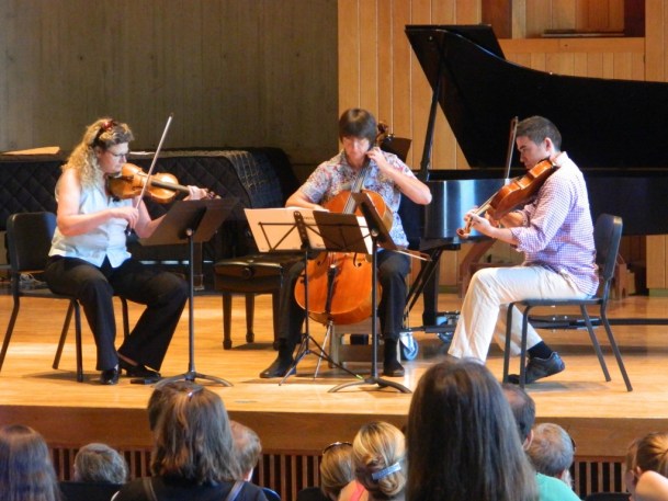 A Craftsbury Chamber Players trio of violinist Mary Rowell, cellist Frances Rowell and violinist Kenji Bunch plays a min-concert for children. The informal afternoon concerts for young people are a staple of the Chamber Players' summer season. Photo by Ashley Phelps, courtesy of the Craftsbury Chamber Players