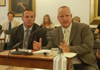 Vermont State Police Lt. Detective James Cruise (left) listens to Col. Tom L'Esperance speak on child protection in Vermont at a hearing on Wednesday, July 23, 2014, at the Statehouse. Photo by Laura Krantz/VTDigger.org