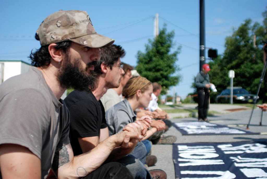 Natural gas pipeline opponents blocked the front entrance to Vermont Gas’ staging area in Williston on Wednesday morning. Photo by John Herrick/VTDigger  