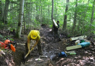 Long Trail patrol crew leader Annie Seder and crew member Matt Oickle construct improvements on the footpath above Smugglers Notch earlier this month. Funding summer work crews is one of the financial challenges facing the Green Mountain Club, Executive Director Mike DeBonis says. The state and federal governments have reduced their support of trail work, so the club must look elsewhere for support. Photo by Jocelyn Hebert, courtesy of the Green Mountain Club. 