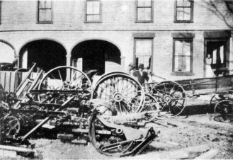 Arthur Batchelder, far left, interpreted "hardware" liberally. The railroad ran nearby, and he took advantage of its proximity to acquire an extensive inventory that included all kinds of tools and machinery that farms needed. The front yard became both storeroom and showroom. Photo courtesy of Plainfield Historical Society.