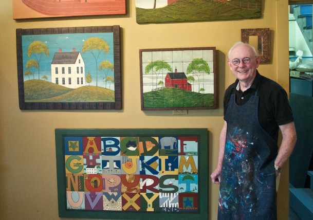 Warren Kimble, one of America’s foremost contemporary folk artists, stands next to a few of his works at his home in Brandon. Photo by Dirk Van Susteren