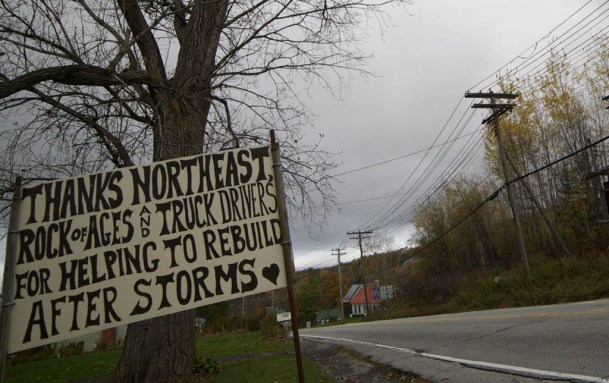 A sign on a lawn neighboring the access road to the Northeast Materials Group's asphalt plant in Barre Town. Photo by John Herrick/VTDigger 
