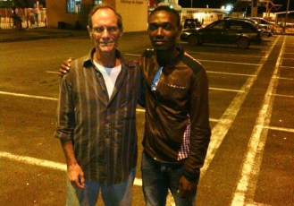 Peter Italia outside Conakry airport in Guinea with his friend and guide Francis, who is from Sierra Leone. Peter Italia Facebook photo