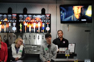 Growler Garage co-owner Liam O'Farrell (right) and staffers for Republican gubernatorial candidate Scott Milne staffers look on at a news conference Wednesday afternoon. Photo by Hilary Niles/VTDigger