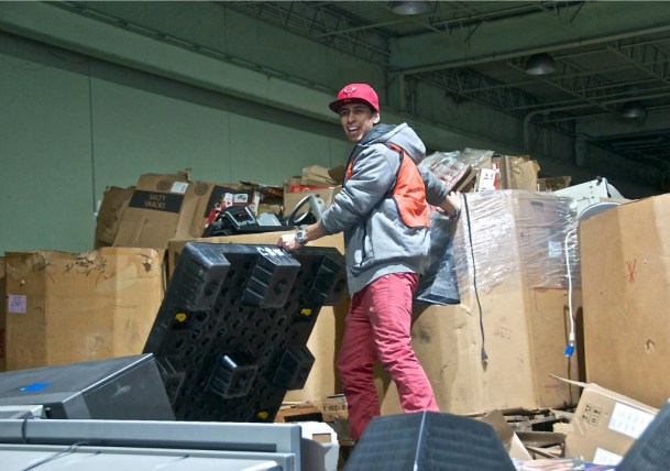 A worker at Good Point Recycling stands atop a pile of electronic trash at the recycling business in Middlebury. Photo by Dirk Van Susteren