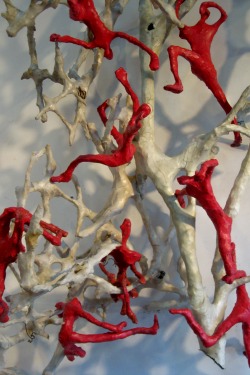 In downsizing the vision of their future after their spectacular success, Riki Moss elected to work on a smaller scale, too. The red figures in "Migration," each about eight inches tall, tell their stories through the tension in their bodies and elongated limbs. With the abaca paper shrunk tightly to their wire frames, like skin, and without individual distinguishing features, every figure is every person who has ever been displaced by world events. Photo by Nancy Graff